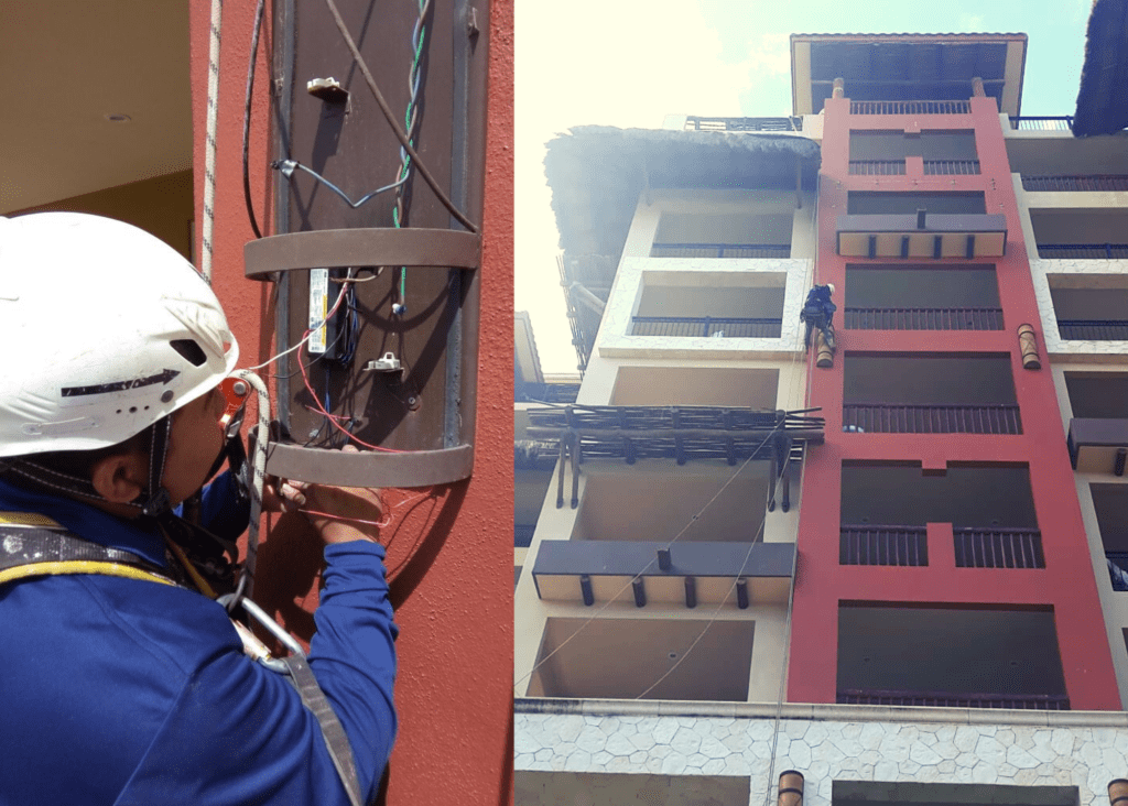 Técnico vertical cambiando las luminarias de un hotel