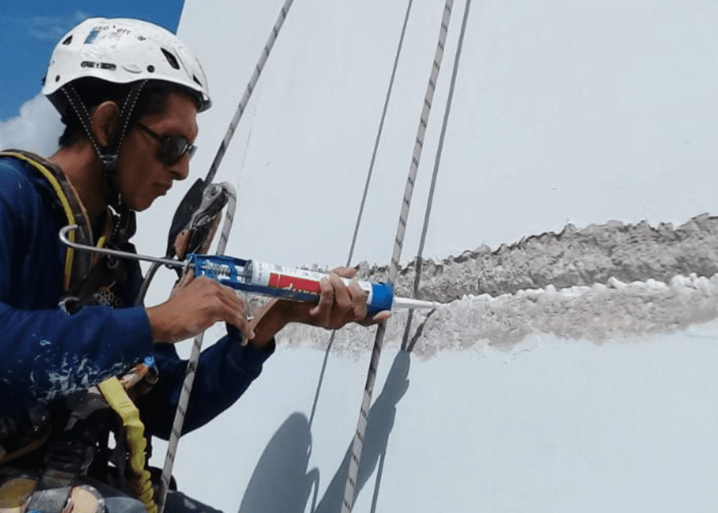 Técnico vertical realizando el sellado de una grieta